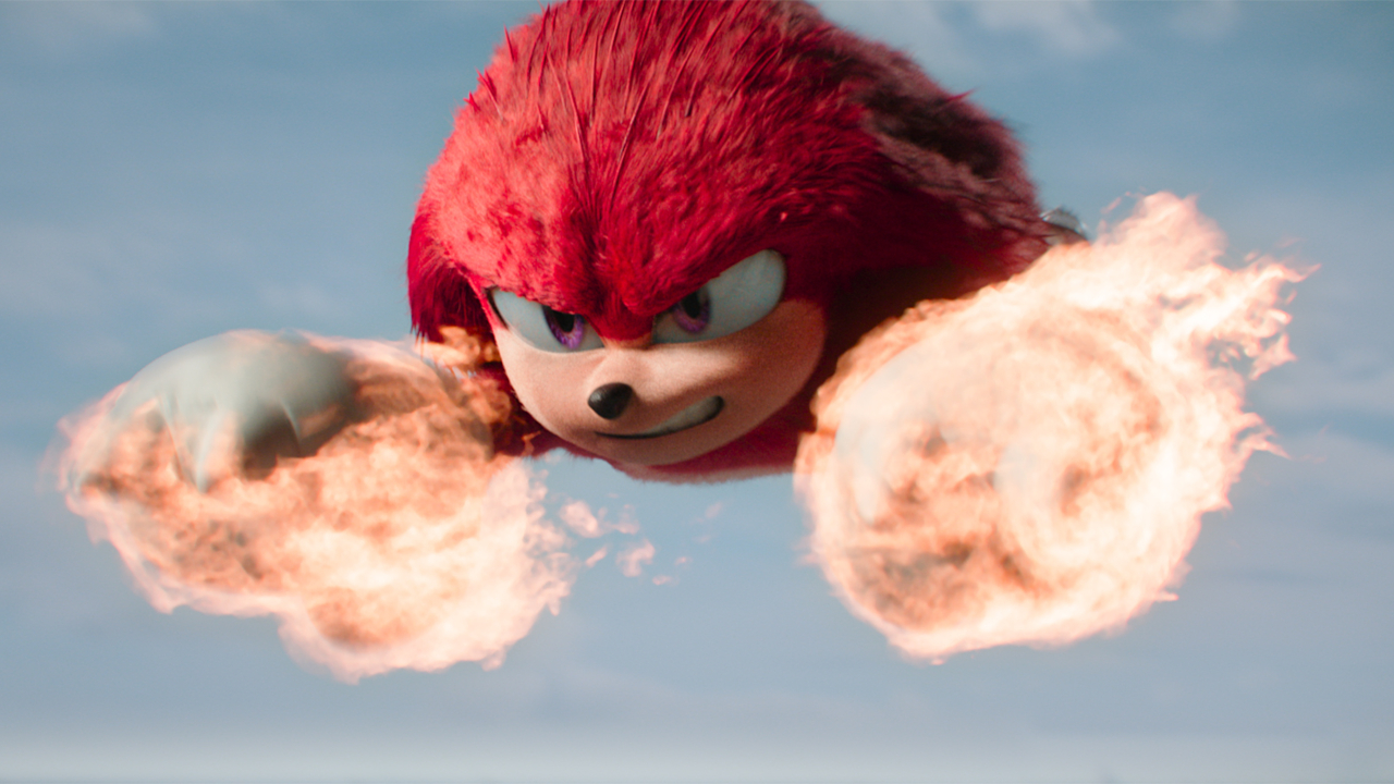 Knuckles flies through the air with his fists on fire in Sonic the Hedgehog 3.