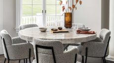 a dining table with cozy chairs