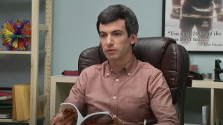 Nathan Fielder reading magazine in office chair in Nathan For You