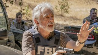 Rossi in vest holding gun on Criminal Minds: Evolution