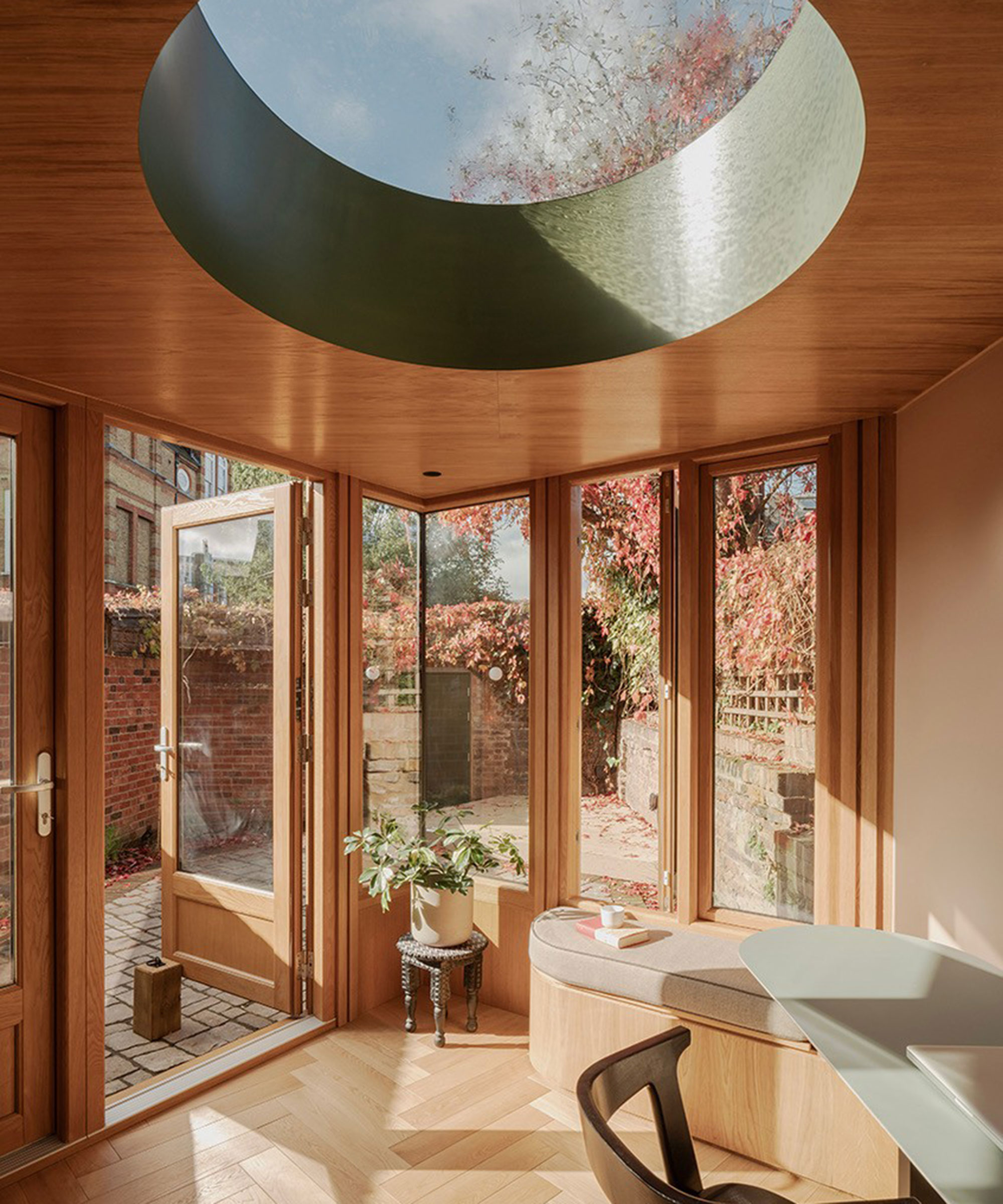 small extension with round dome roof lantern and French doors to small courtyard