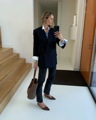 Fashion influencer @anoukyve in Europe wearing a chic outfit for 2025 styled with a blazer.