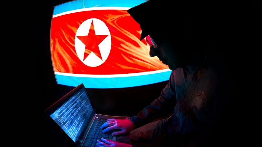 a North Korean hacker in front of the DPRK flag