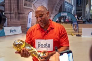 John Barnes lifted the trophy for the victorious team