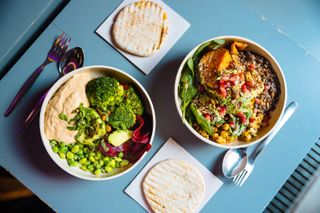 Vegan bowls with various vegetables and seeds, high angle view - stock photo