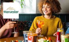 Harvester logo placed over an image of two people dining in one of the restaurants