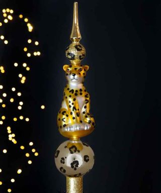 Gold animal print Christmas Tree Topper with leopard figurine sitting on baubles