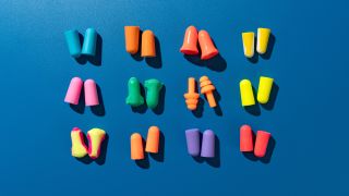 A selection of earplugs on a blue background