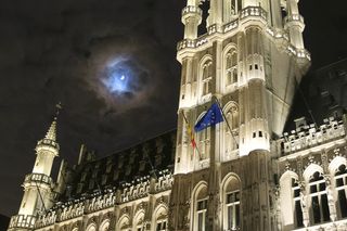A colorful lunar corona above Grand Place, in Brussels city, Belgium. 