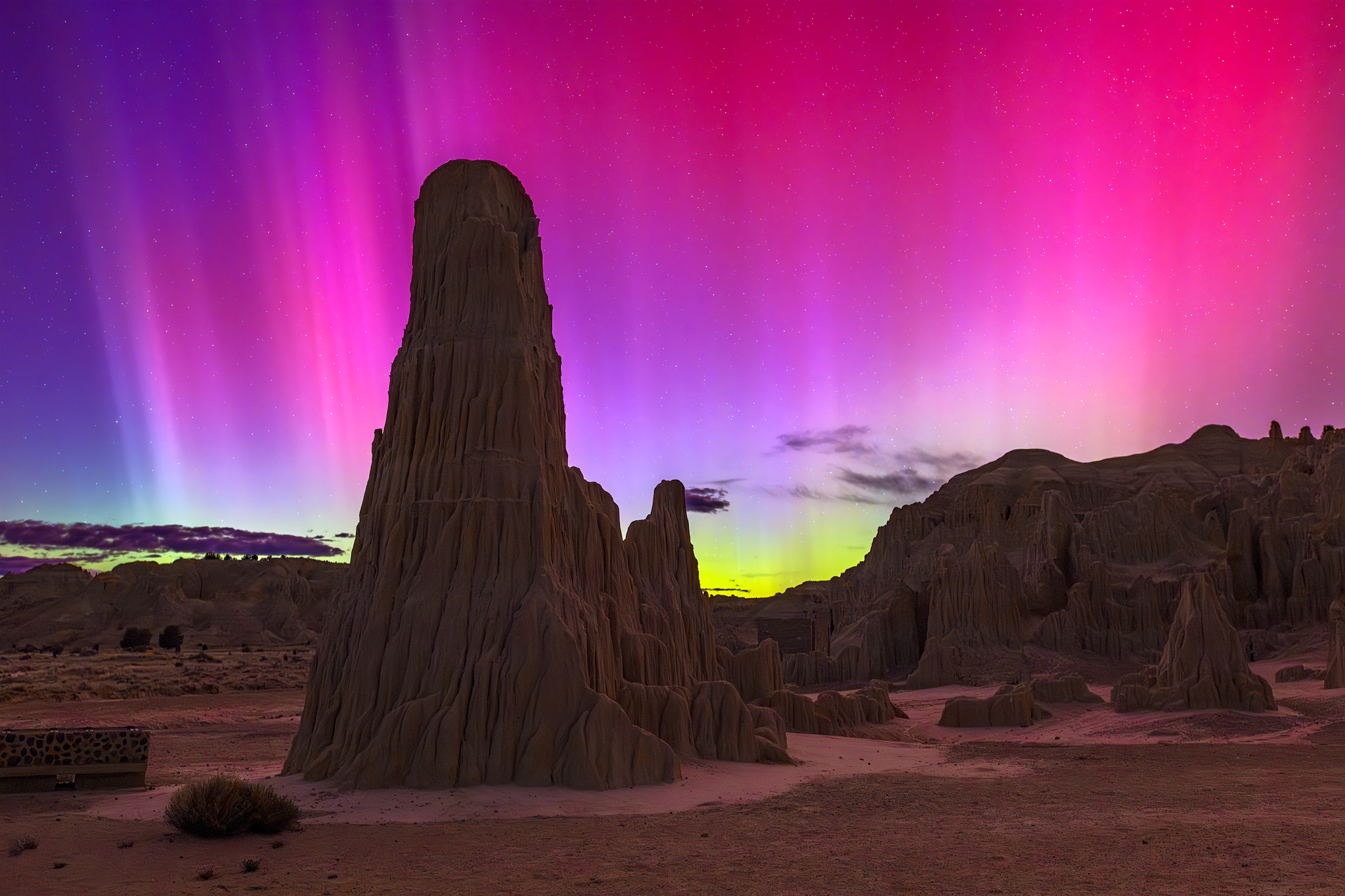 A photograph taken by pilot Ralf Rohner of the aurora behind a rock formation