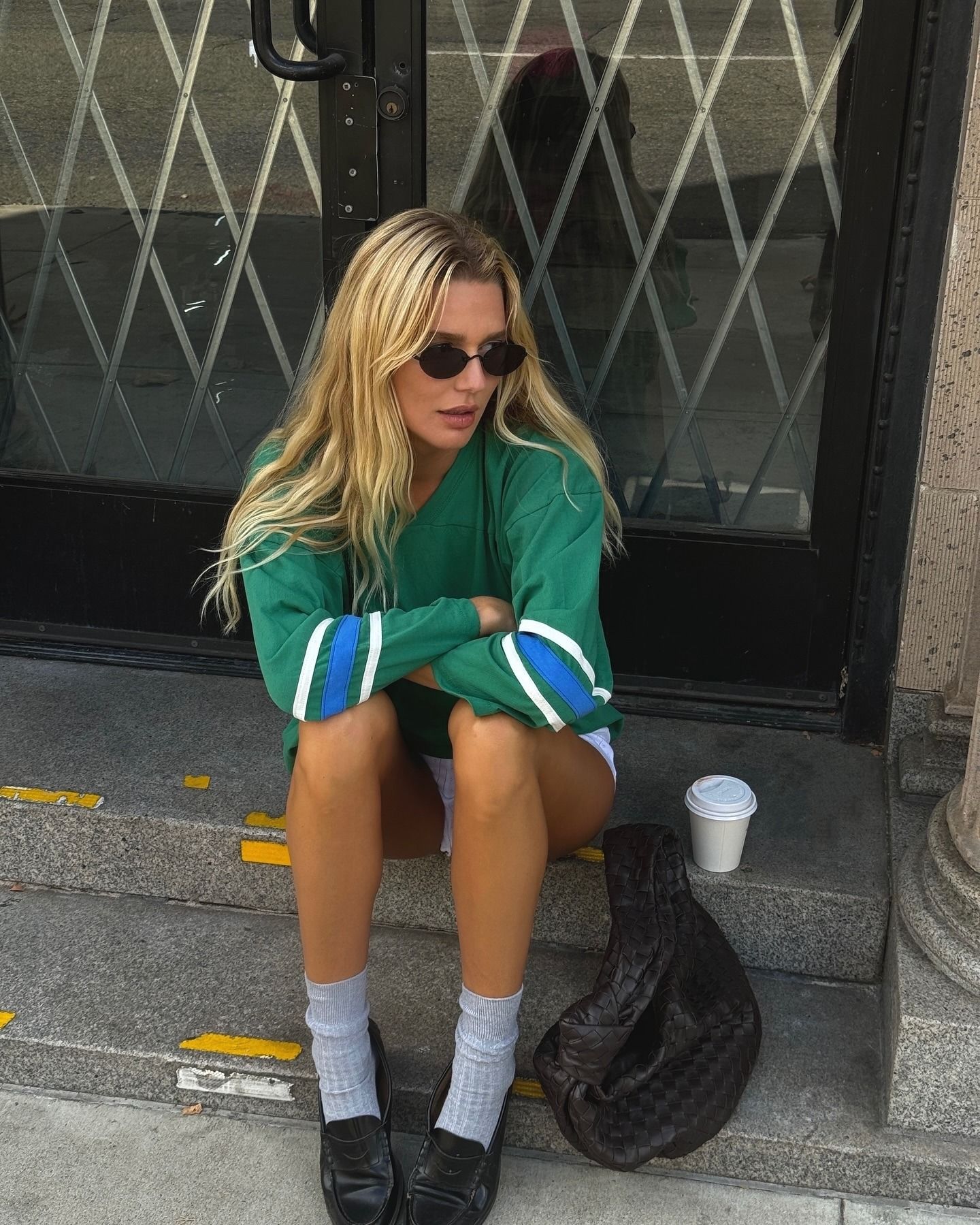 Creator @meganadelaide sitting outside on a step