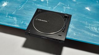 An Audio-Technica record player on a blue table
