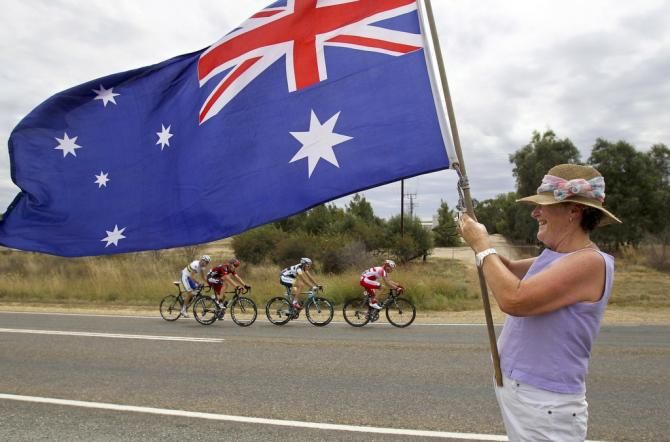 An Australian flag flies in the breeze as the peloton makes it way to Clare