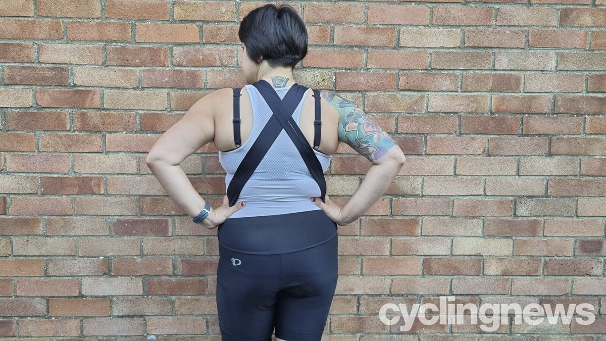 Mildred Locke wearing Pearl Izumi Women's Expedition Shorts, facing away from the camera to show the cross-over straps on the rear