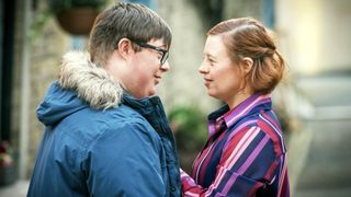 Ralph & Katie - Leon Harrop in a blue coat with furry hood faces Sarah Gordy in a pink and purple striped shirt as Ralph and Katie.