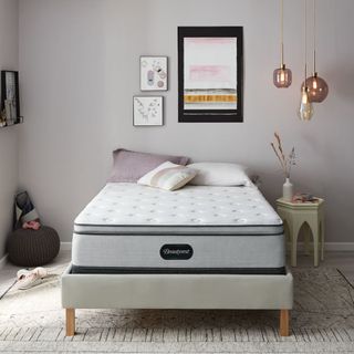 Beautyrest Pillow Top mattress on a bed against a gray wall.