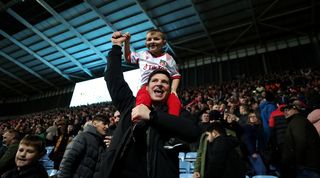 Wrexham fans celebrate during their team's 4-3 win over Coventry City in the FA Cup third round.