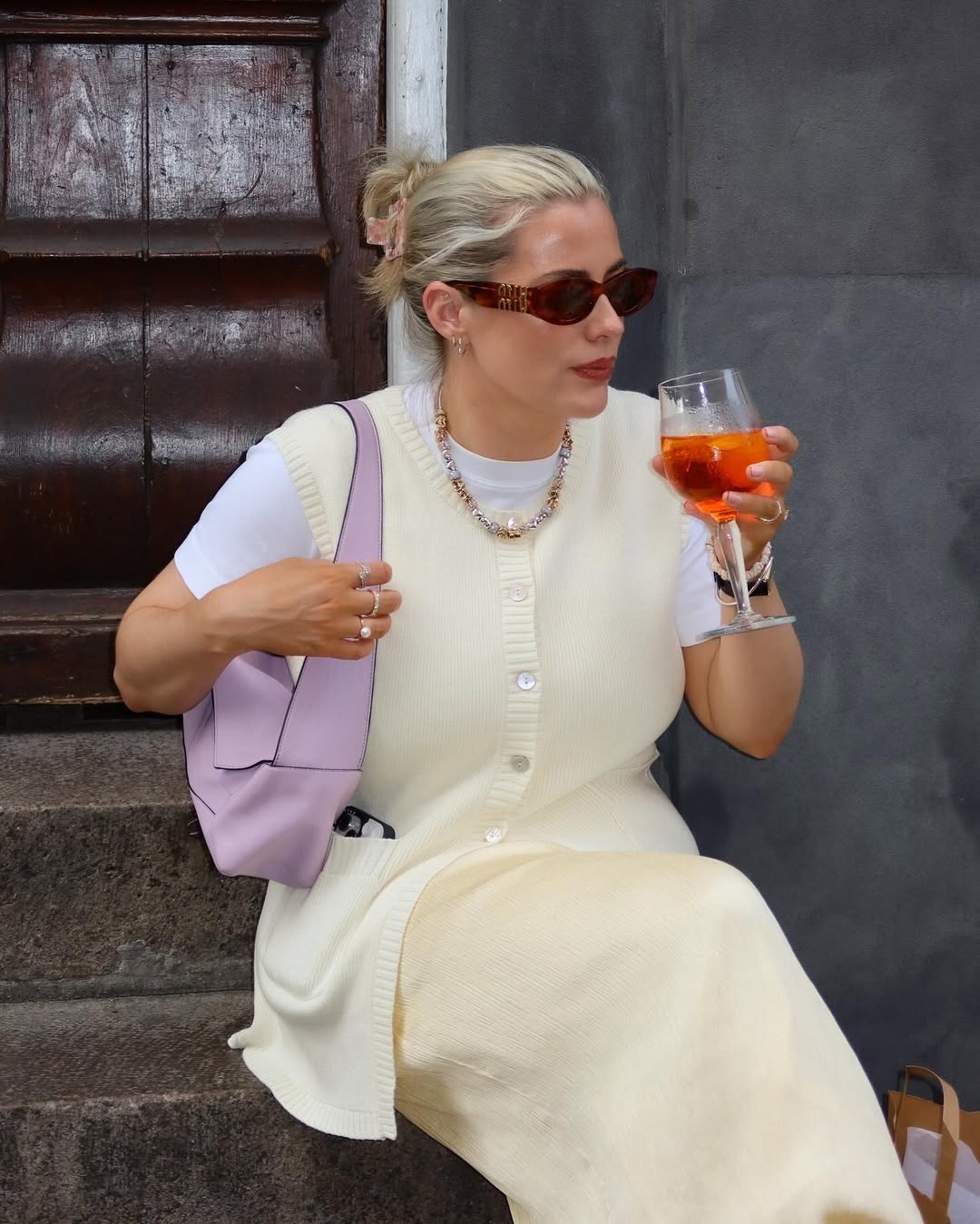 woman sitting down having a drink