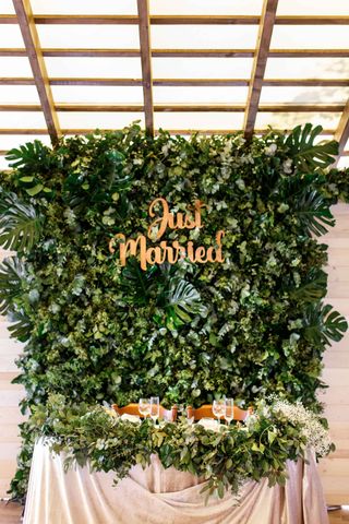 foliage flower wall with just married sign