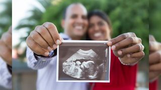 couple holding a sonogram image
