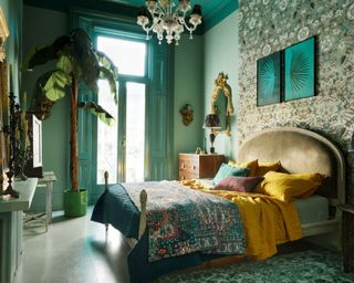green maximalist bedroom with large plant and balcony doors