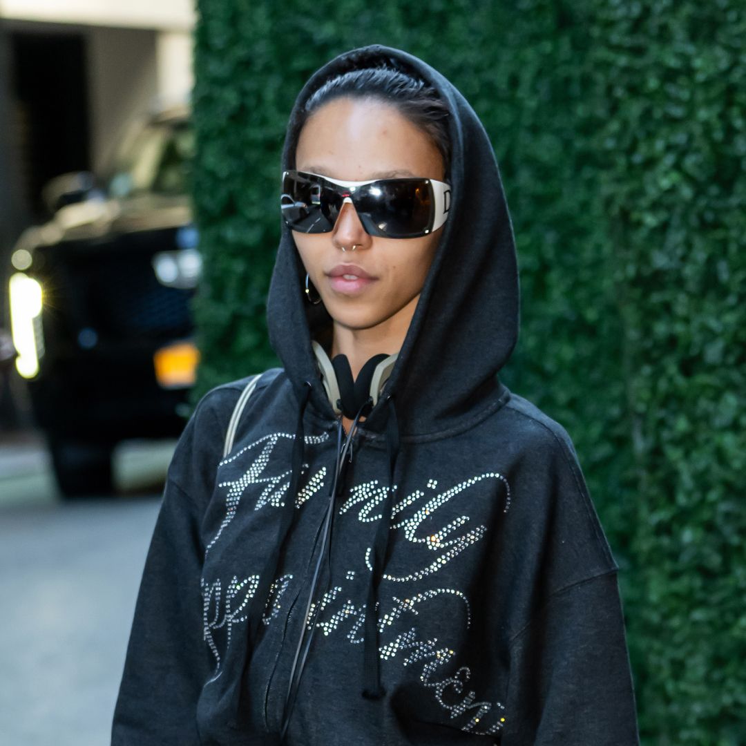 FKA twigs in a hoodie with large sunglasses