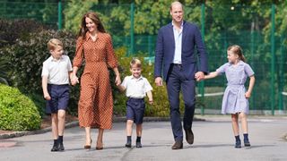 Prince George, Princess Charlotte and Prince Louis (C), accompanied by their parents the Prince William, Duke of Cambridge and Catherine, Duchess of Cambridge, arrive for a settling in afternoon at Lambrook School