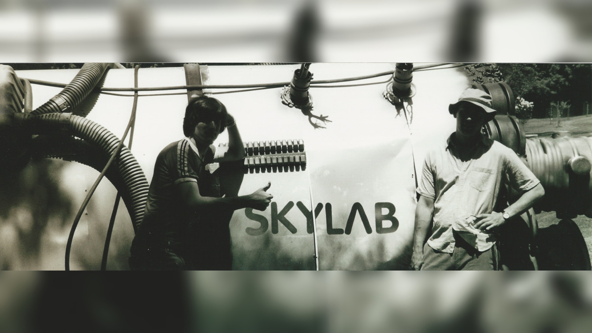 Actors in front of Skylab model.