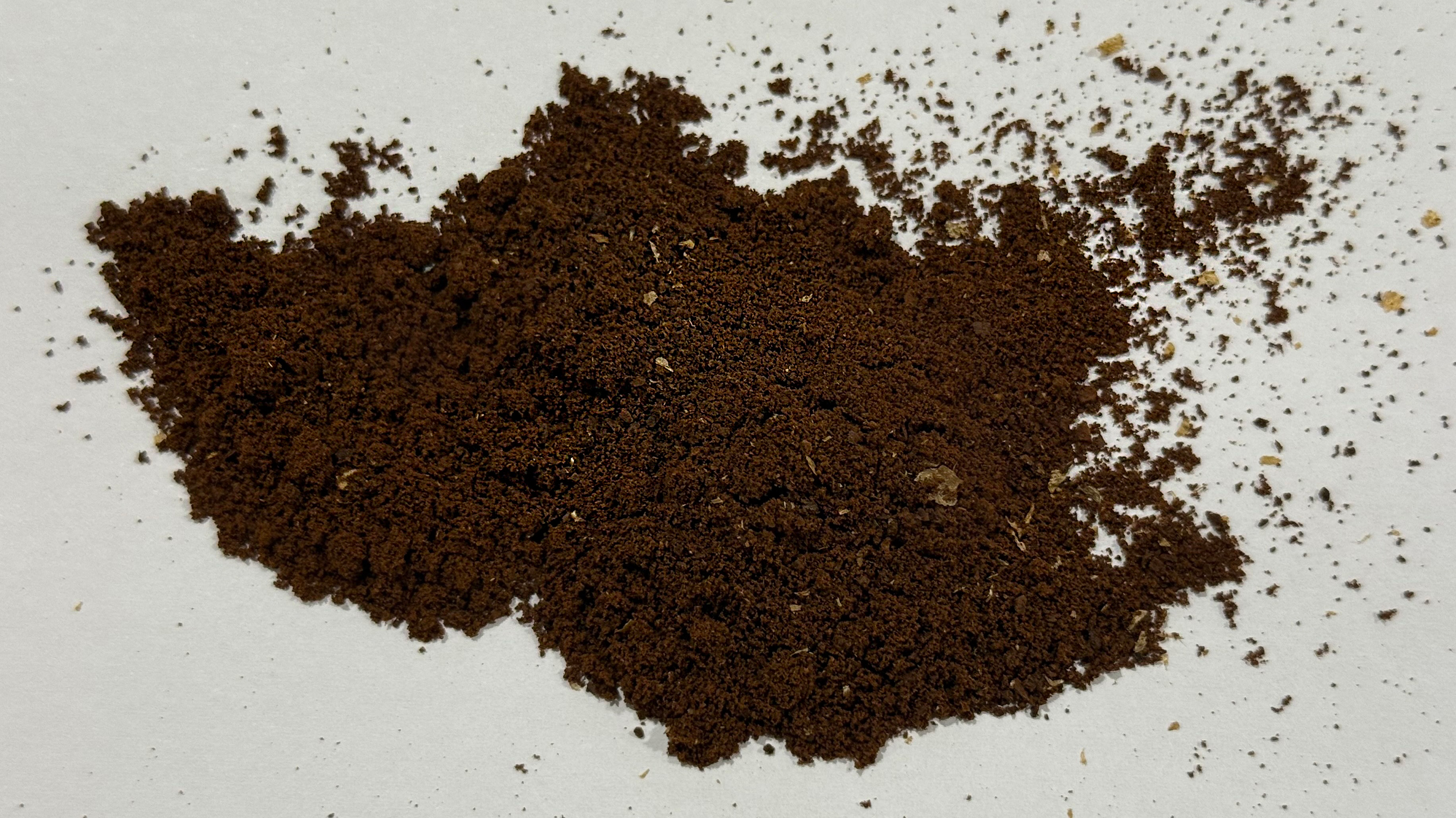 a photo of ground coffee ground on the mazzer philos showing clumping