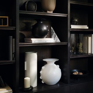 M&S x Kelly Hoppen vases displayed in a black bookcase