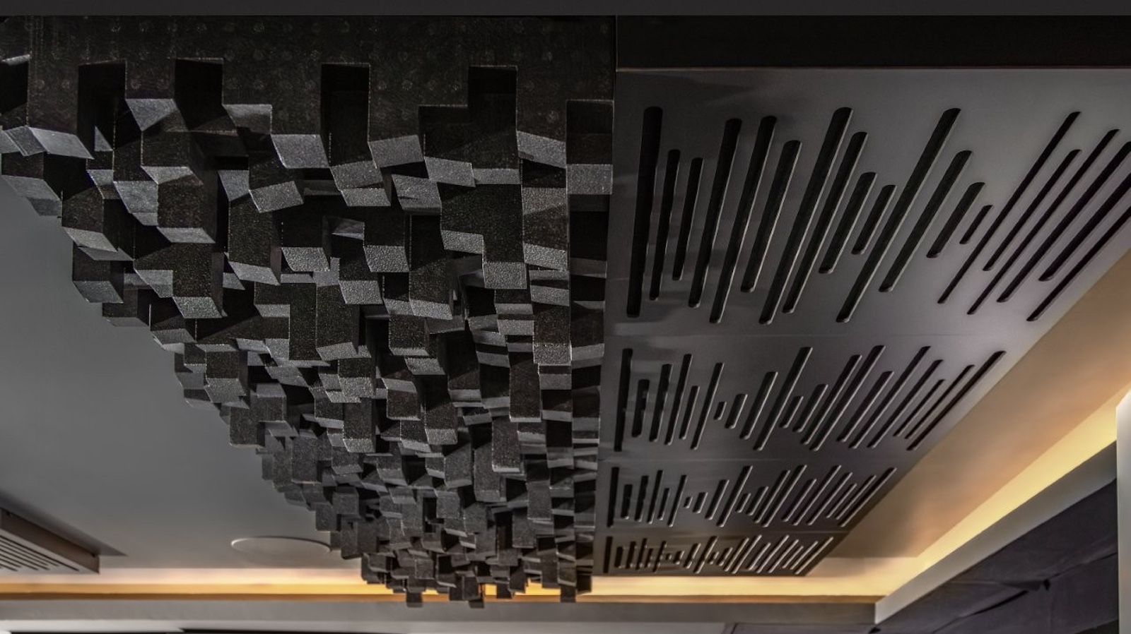 A photo of a custom-installed home cinema room featuring a 4K projector, theatre seating and clever acoustic treatment