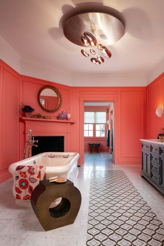 A coral colored bathroom and fireplace