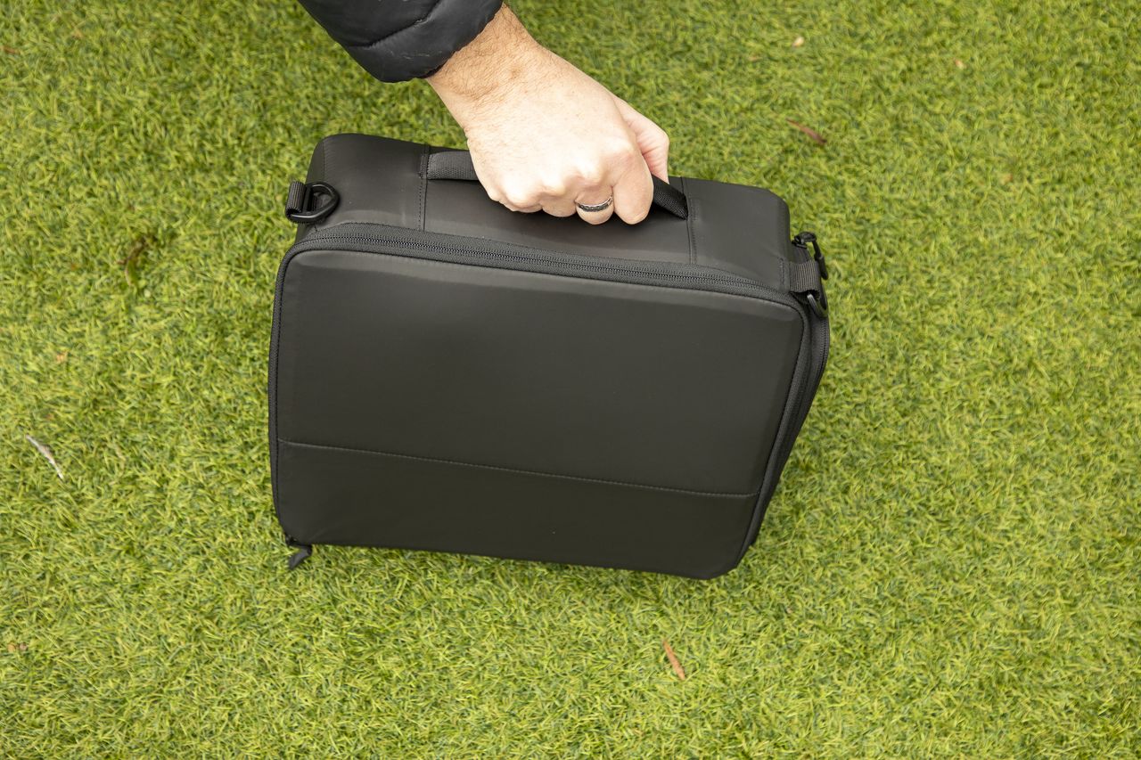 inside a camera backpack with internal dividers, being removed