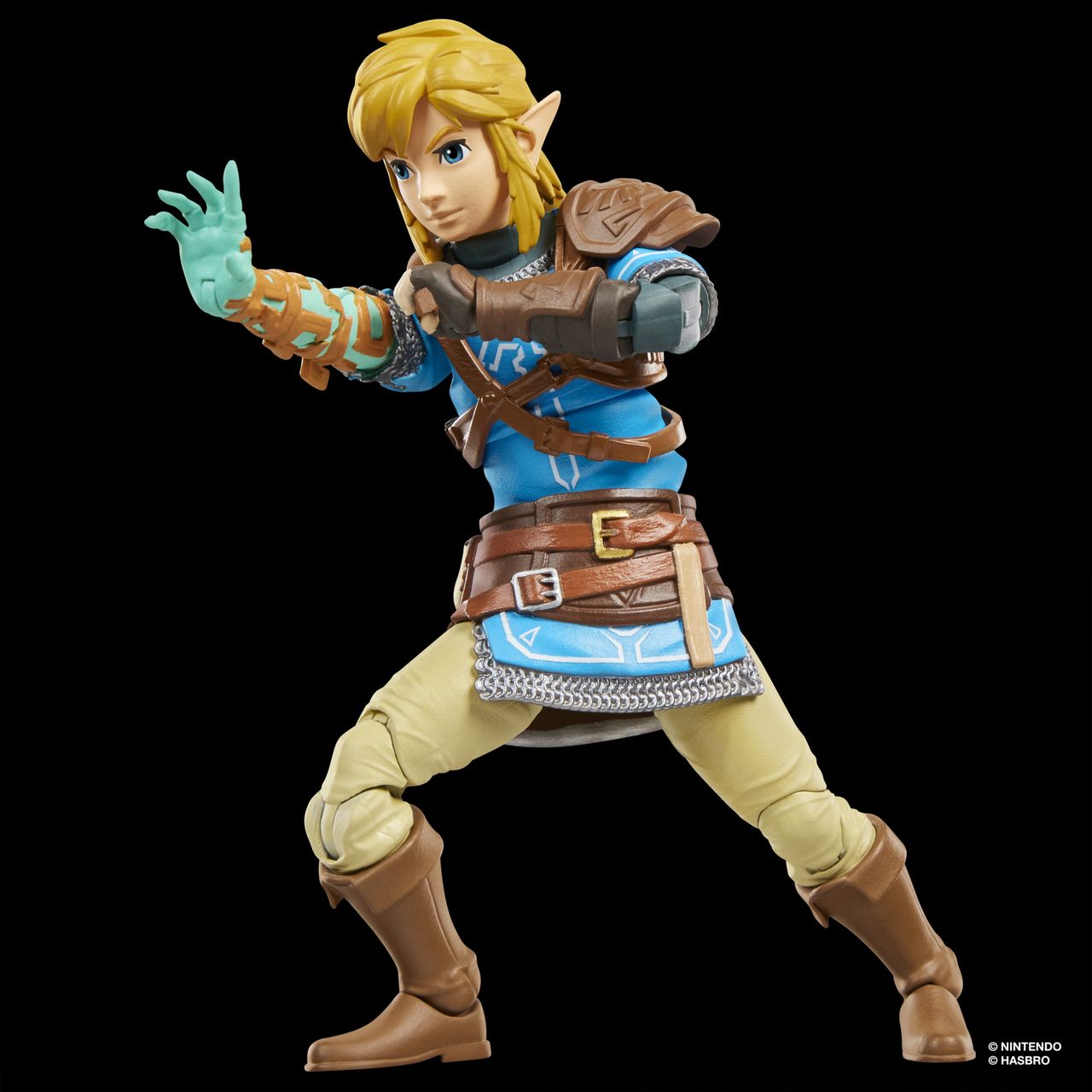 An action figure of Link from Tears of the Kingdom stands against a dark background
