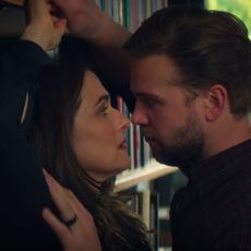 rachel weisz and leo woodall pushed against a book shelf in a still from vladimir