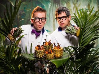 Pair of scientists emerging from jungle foliage