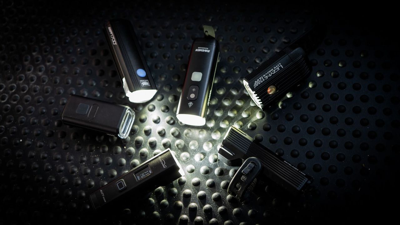 Best Bike Lights grouptest lead image by Cycling Weekly 2025. 6 bike lights all turned on facing each other in a circle. 