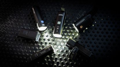 Best Bike Lights grouptest lead image by Cycling Weekly 2025. 6 bike lights all turned on facing each other in a circle. 