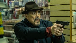 Batista holding gun inside store in Dexter: Resurrection Episode 8