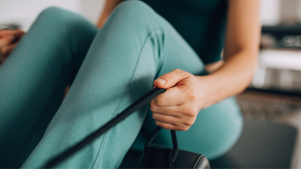 A woman doing an intermediate resistance band workout from home