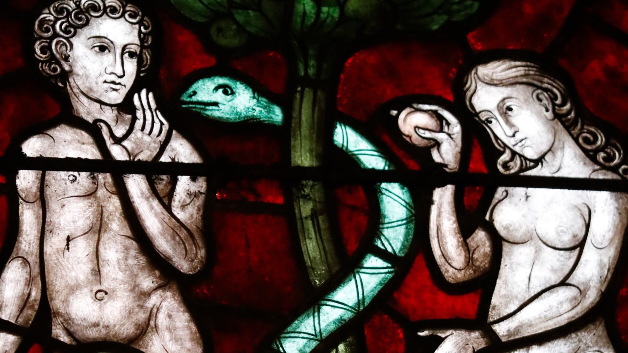 Adam, Eve and the serpent depicted on a stained glass window