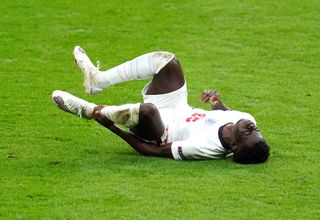 Bukayo Saka goes down injured against Germany