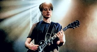 Jack Moore frets a chord on his black Les Paul Standard.