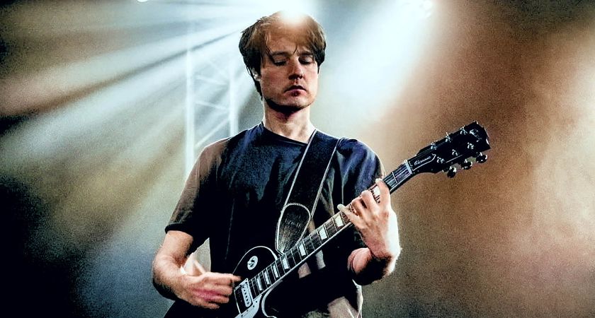 Jack Moore frets a chord on his black Les Paul Standard.