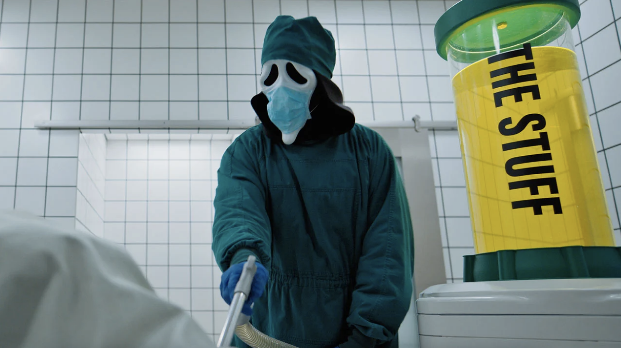 A masked Ghostface in a bathroom injects someone with a yellow liquid known as &amp;quot;the stuff,&amp;quot; similar to the 2024 film 'The Substance.'