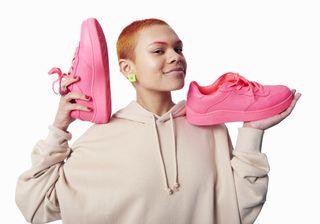 Fashionable Person holding trainers