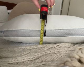 Coop Eden Cool+ Pillow measuring depth on bed
