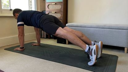 Man holding a plank