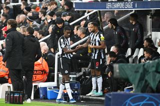 Alexander Isak of Newcastle United is consoled by teammate Callum Wilson as he leaves the field after sustaining an injury during the UEFA Champions League match between Newcastle United FC and Borussia Dortmund at St. James Park on October 25, 2023 in Newcastle upon Tyne, England. (Photo by Michael Regan/Getty Images)
