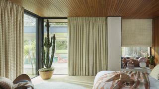 modern bedroom with full height glazing and floor length curtains